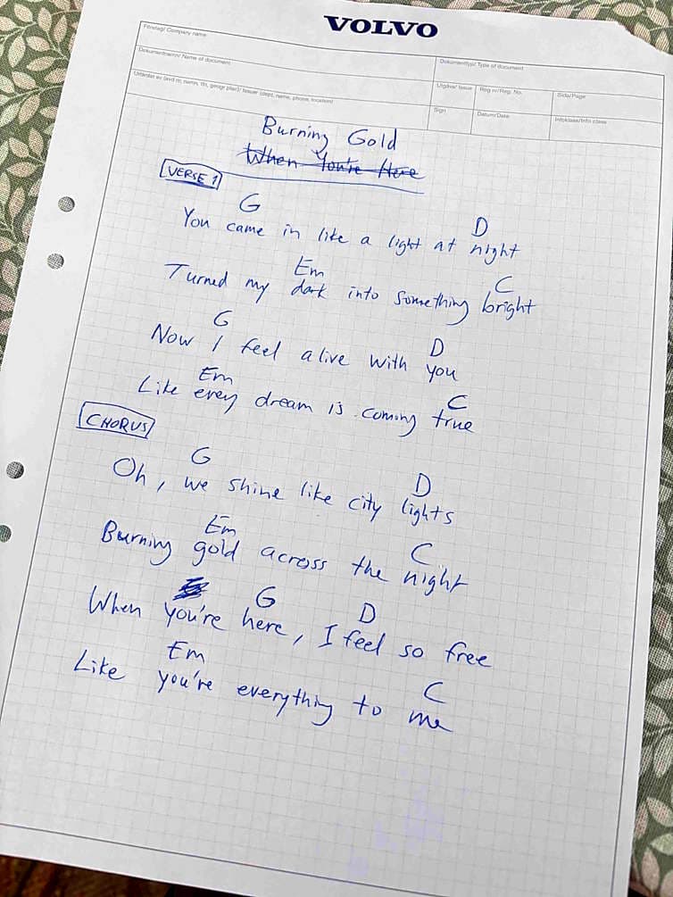 Handwritten chord sheet for Burning Gold on a notepad